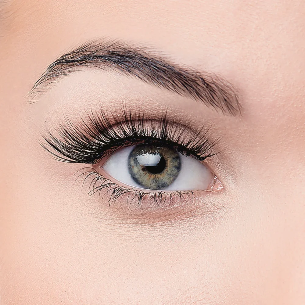 Close-up image of a woman's eye featuring long eyelashes and a striking blue-green iris, highlighting eye makeup and beauty.