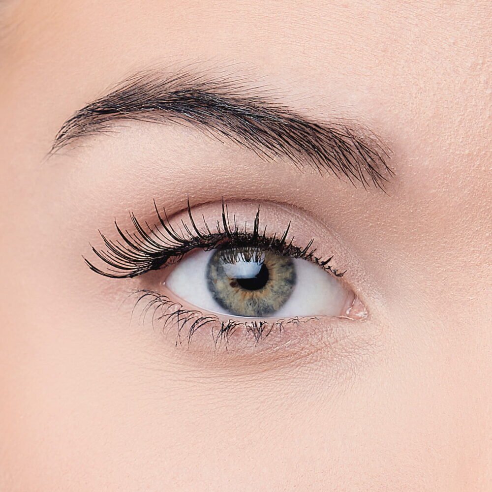 Close-up view of a human eye showcasing natural eyelashes and a striking iris with shades of blue and green, highlighting eye beauty.