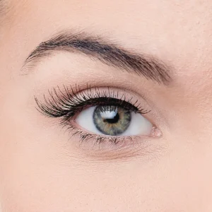 Close-up image of a woman's eye showcasing long eyelashes and a striking iris color, highlighting eye beauty and makeup.