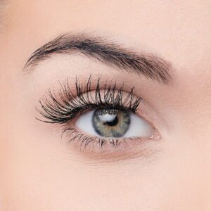 Close-up view of a human eye showcasing long eyelashes and a vibrant iris, emphasizing beauty and eye care products.