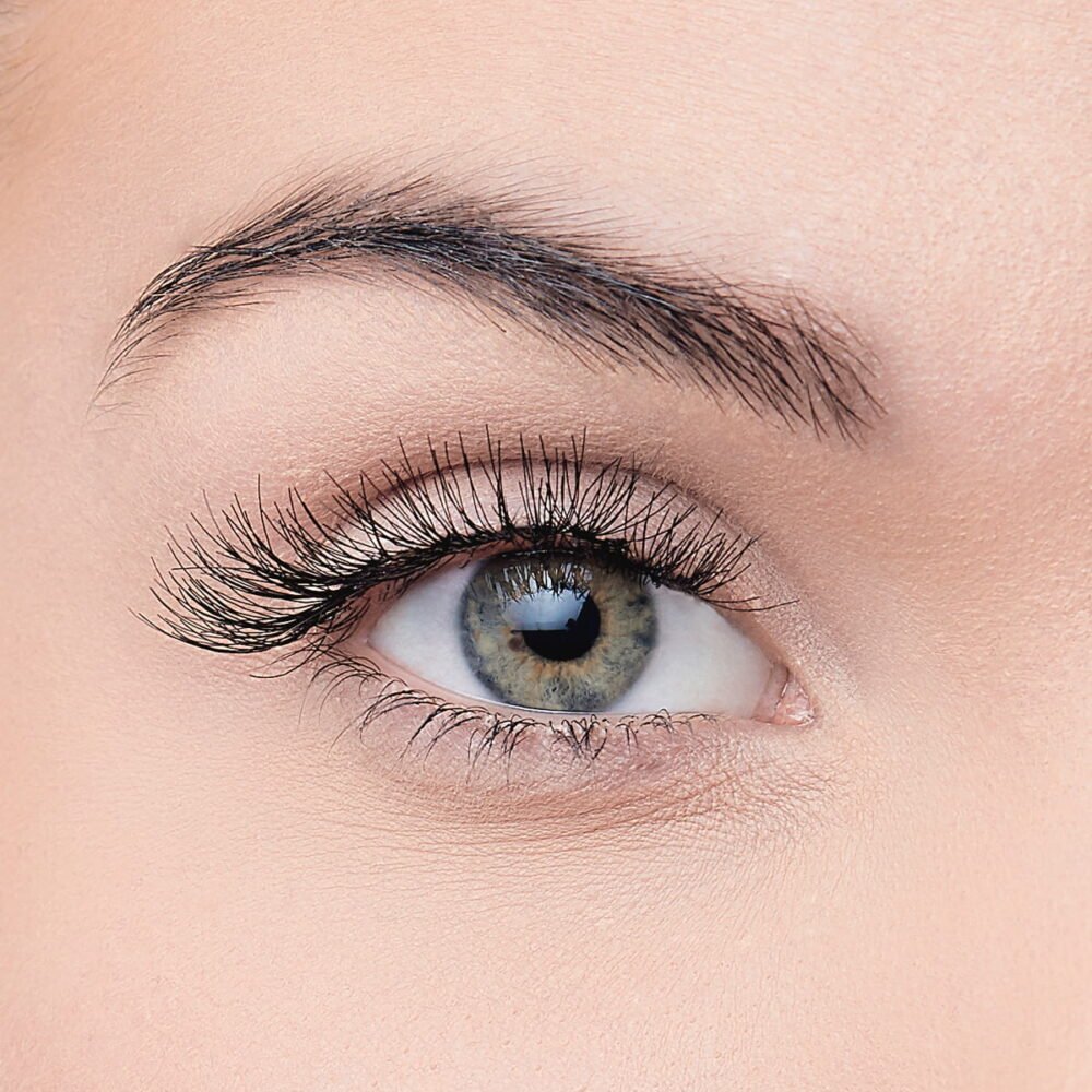 Close-up view of a human eye showcasing detailed eyelashes and a striking iris color, highlighting natural beauty and eye care.