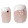 Nail art featuring a floral design with gems on a pink background, showcasing elegant nail enhancements for stylish looks.