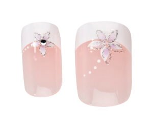 Pink nail art with floral designs featuring white tips and embellishments, perfect for stylish manicures and nail care.