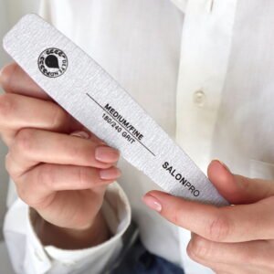 SalonPro medium fine nail file with 180/240 grit held in hand, designed for nail care and shaping.