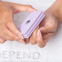 Depend lavender nail buffer held in hands, designed for smoothing and shaping nails, ideal for manicures and pedicures.