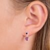 Heart-shaped purple earrings with a sparkling design, featuring a round and heart-shaped gemstone, ideal for elegant jewelry collections.