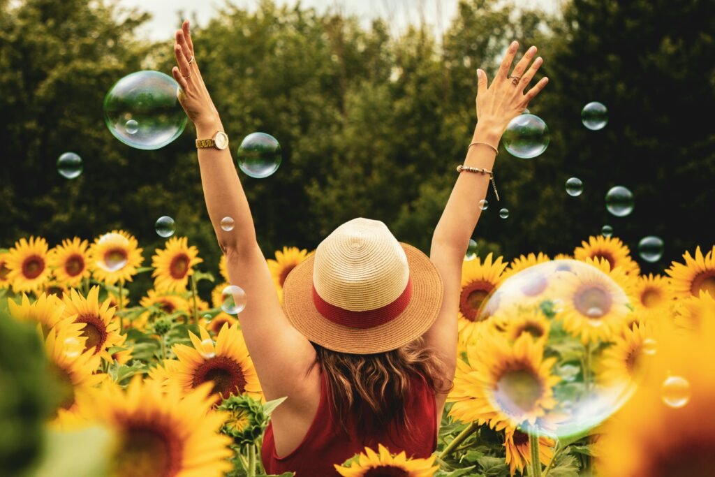 Glowing skin - Woman Surrounded By Sunflowers